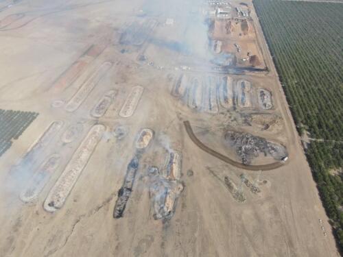 Aerial photo of almond shell piles on fire.