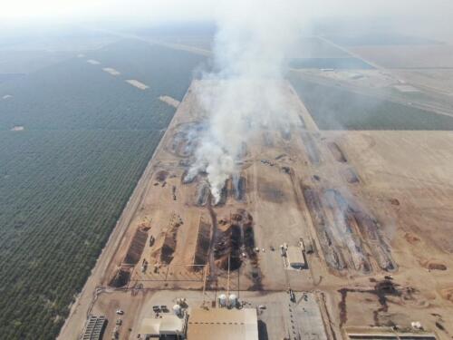 Aerial photo of almond shell piles on fire.